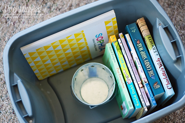 Fill a bin with books, a reading journal, and a way to motivate your children to read this summer.