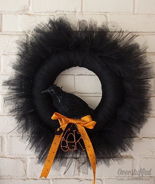 How to make a beautiful black Halloween wreath out of tulle. Add a crow and it is the perfectly scary decoration for your Halloween mantel! #overstuffedlife