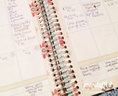 Using a planner to keep track of wardrobe choices for work.