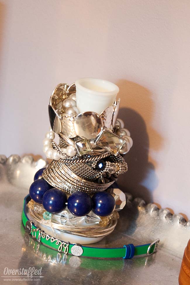 Storing bracelets on a milk glass vase found at a thrift store looks pretty and is functional, too. #overstuffedlife