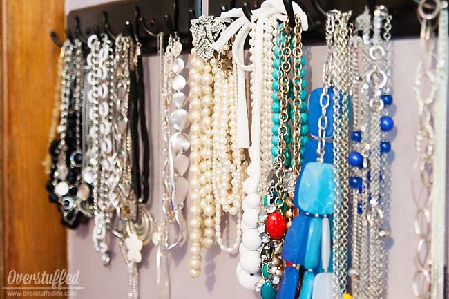 Coat hooks are excellent for storing your necklaces on. It is a stylish way to organize and find your jewelry. #overstuffedlife
