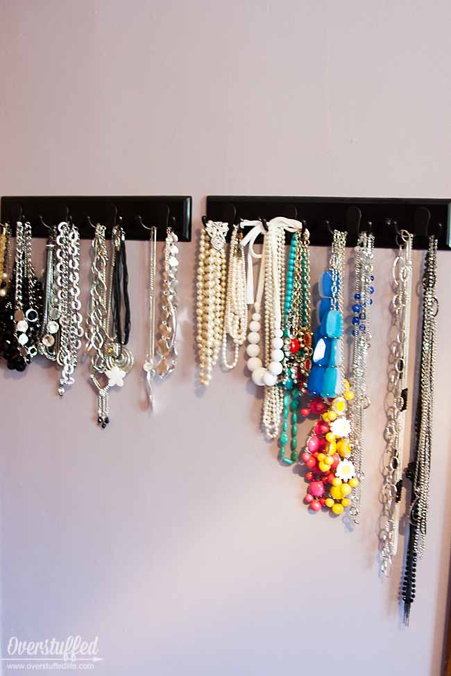 Use coat hooks to organize your necklaces by type, length, and color. #overstuffedlife