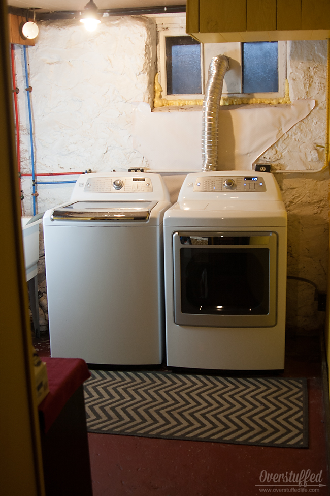Putting a rug in front of your washer and dryer in a basement laundry room is helpful