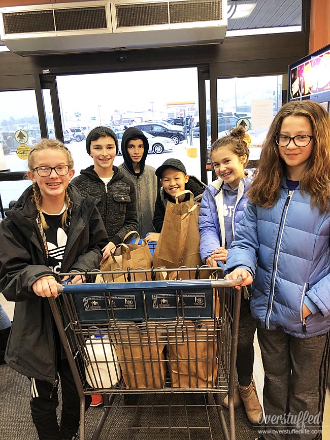 These 6th graders helped a family in need at Christmas by buying them groceries.