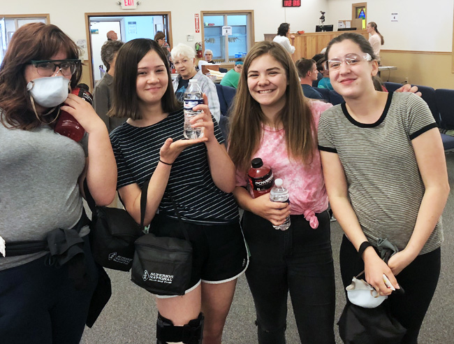 Teenage girls volunteering to clean up debris from Father's Day Flood in Houghton Michigan